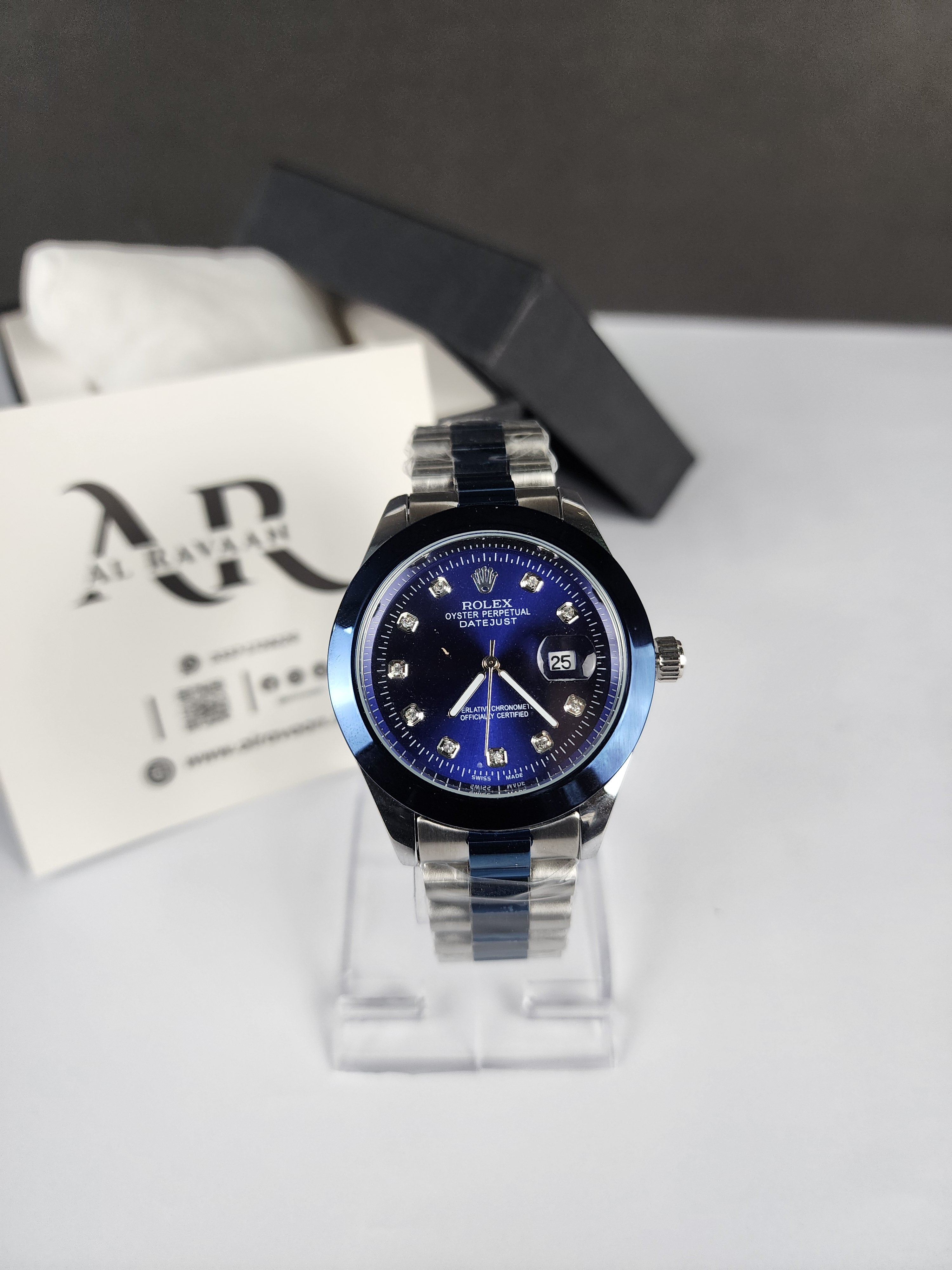 Watch with blue face and silver case on a white surface