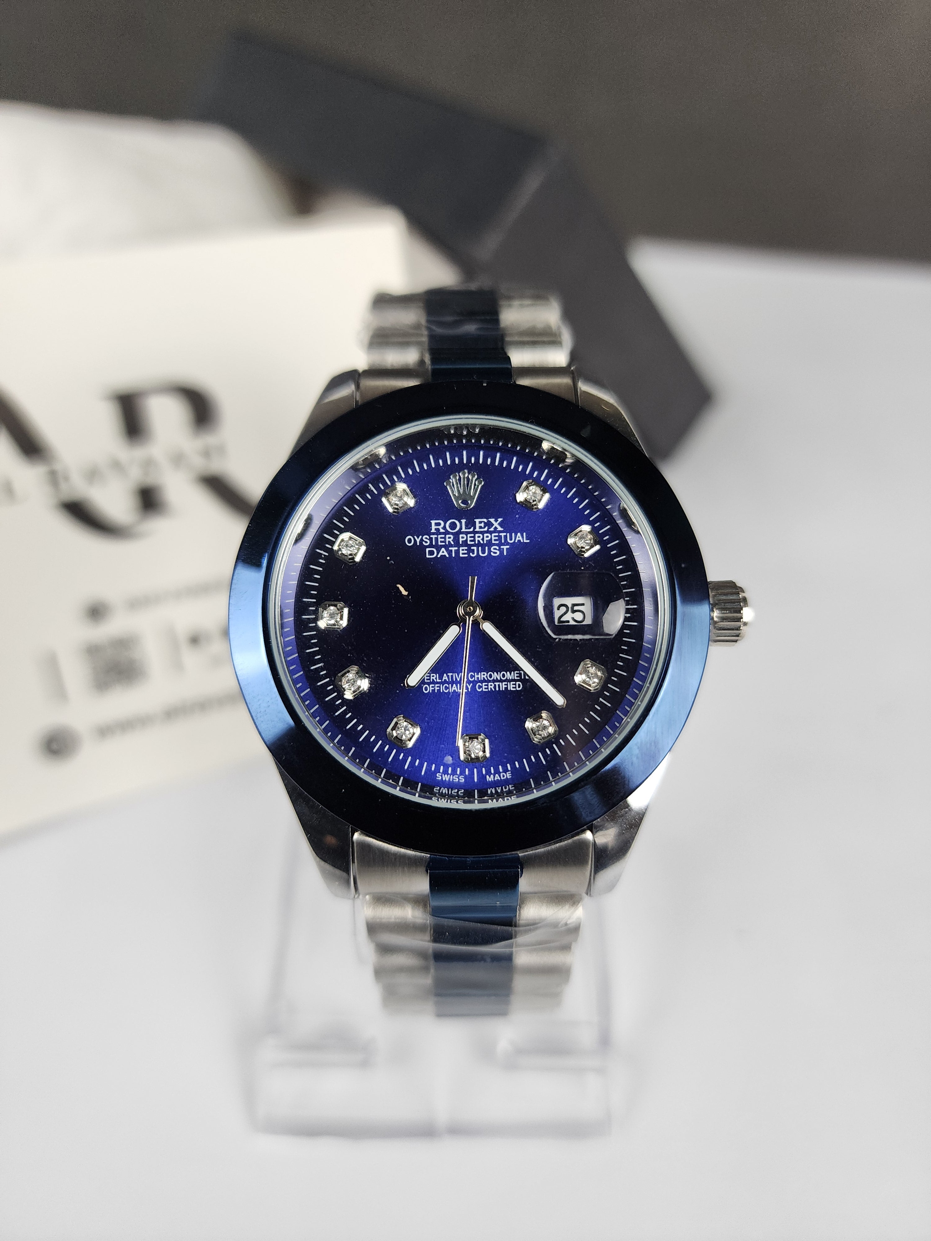 Watch with blue face and silver case on a white background