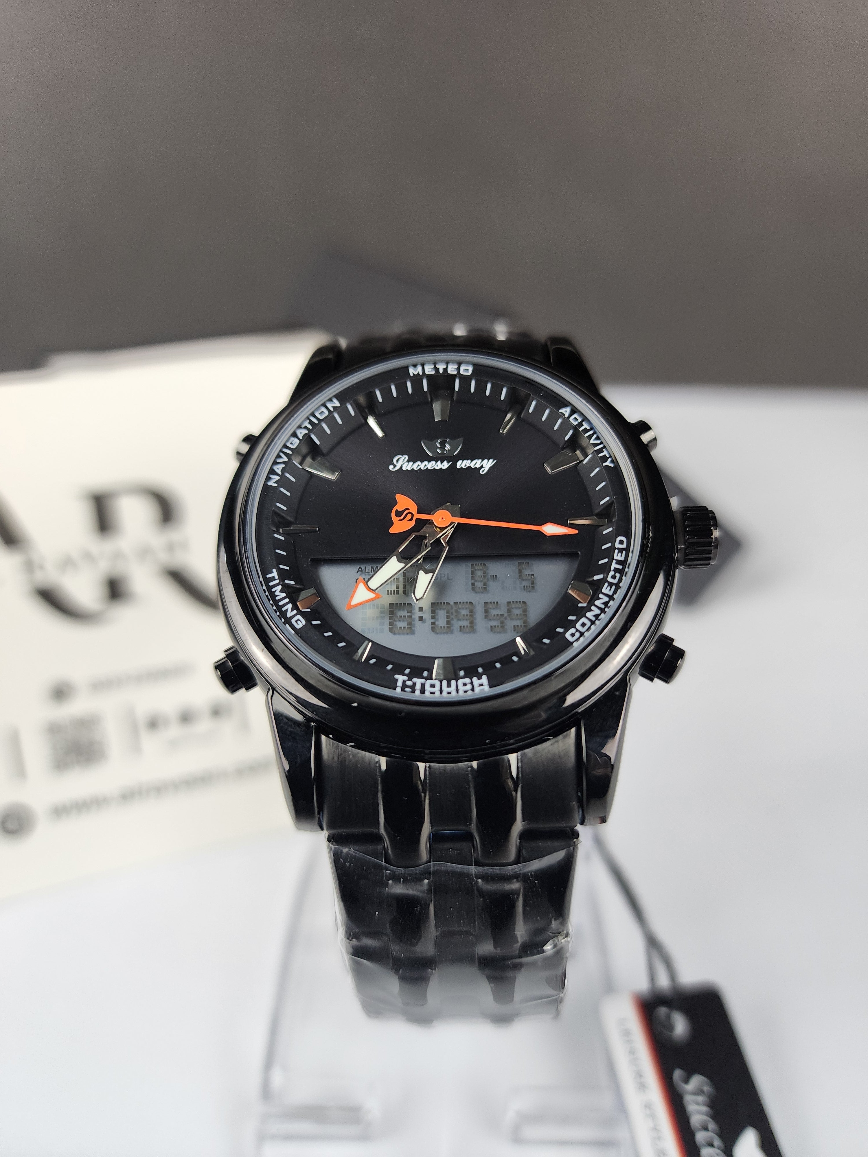 Black wristwatch with digital and analog display on a white background