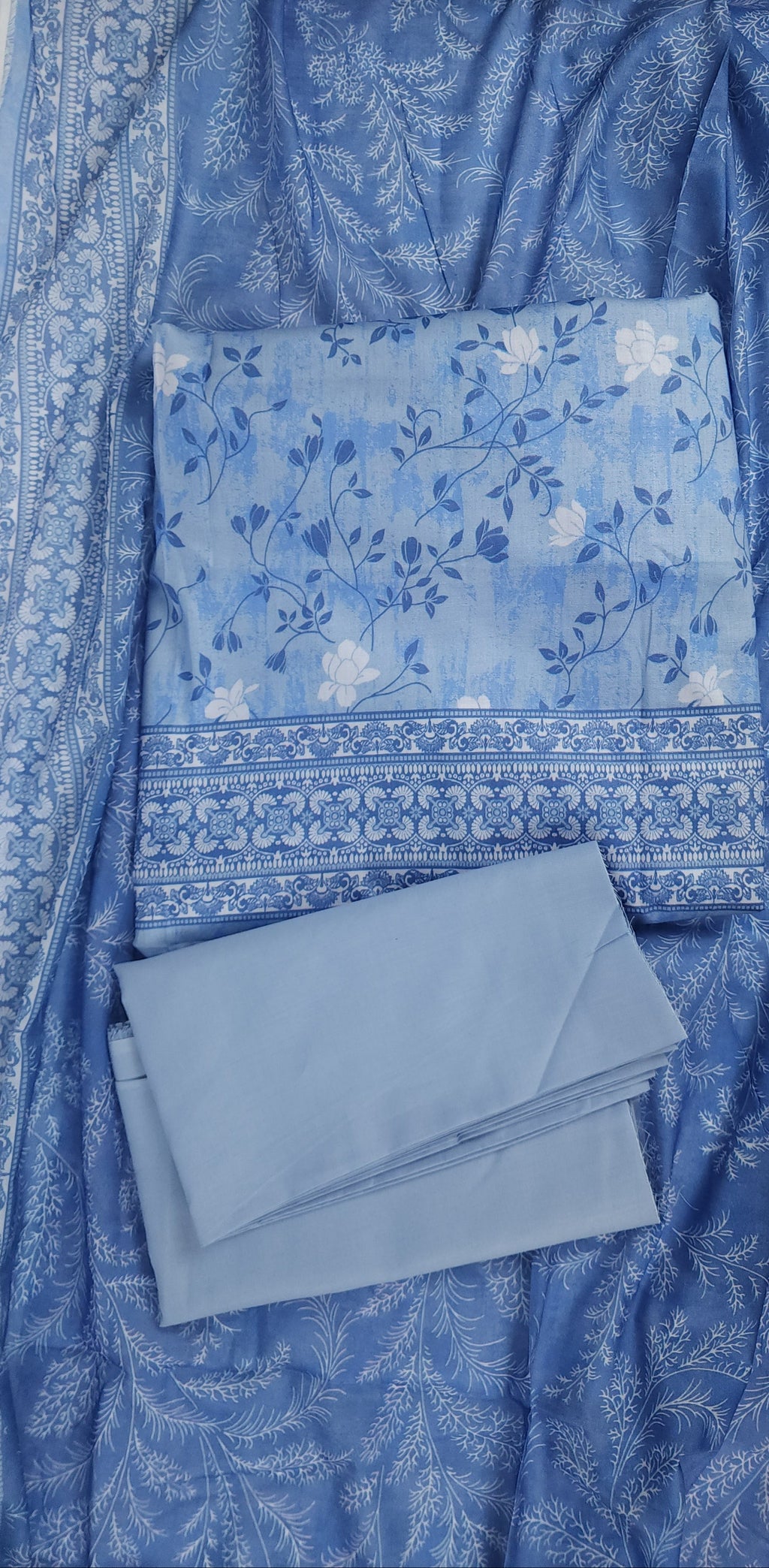 Blue fabric with floral patterns on a flat surface
