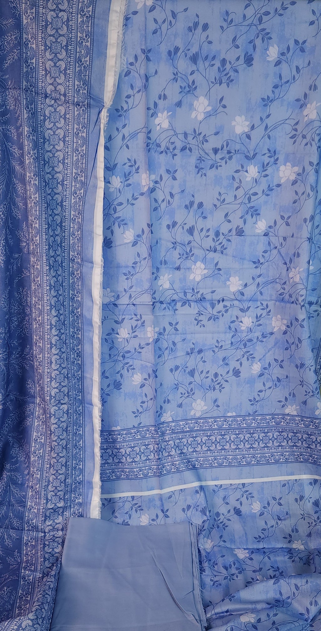 Blue floral patterned fabric with a white border