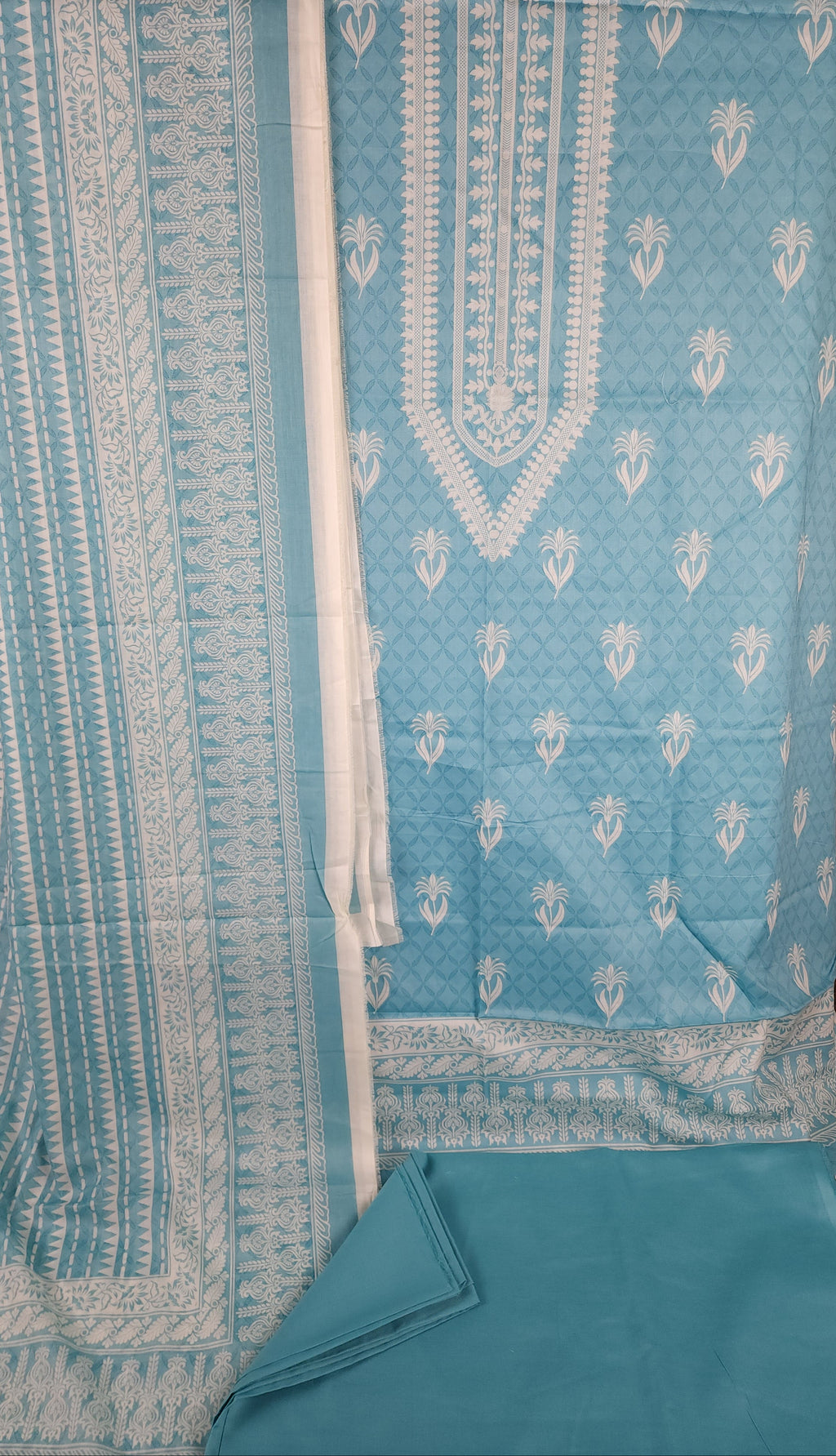 Light blue fabric with white patterns on a brown surface