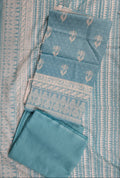 Set of blue fabric items with patterns on a matching fabric background