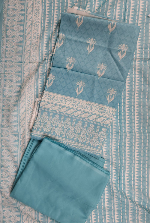 Set of blue fabric items with patterns on a matching fabric background