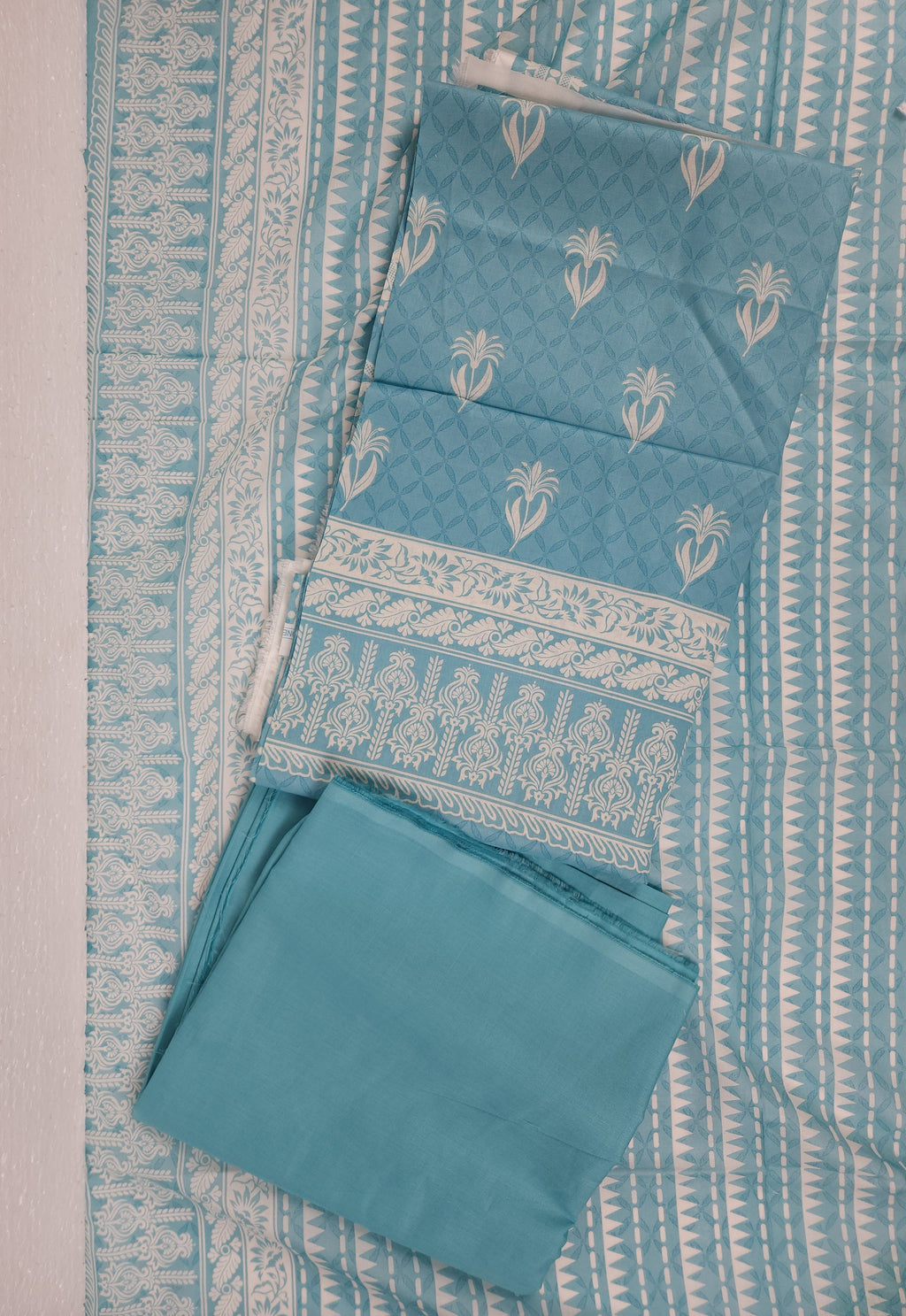 Set of blue fabric with white patterns on a matching fabric background