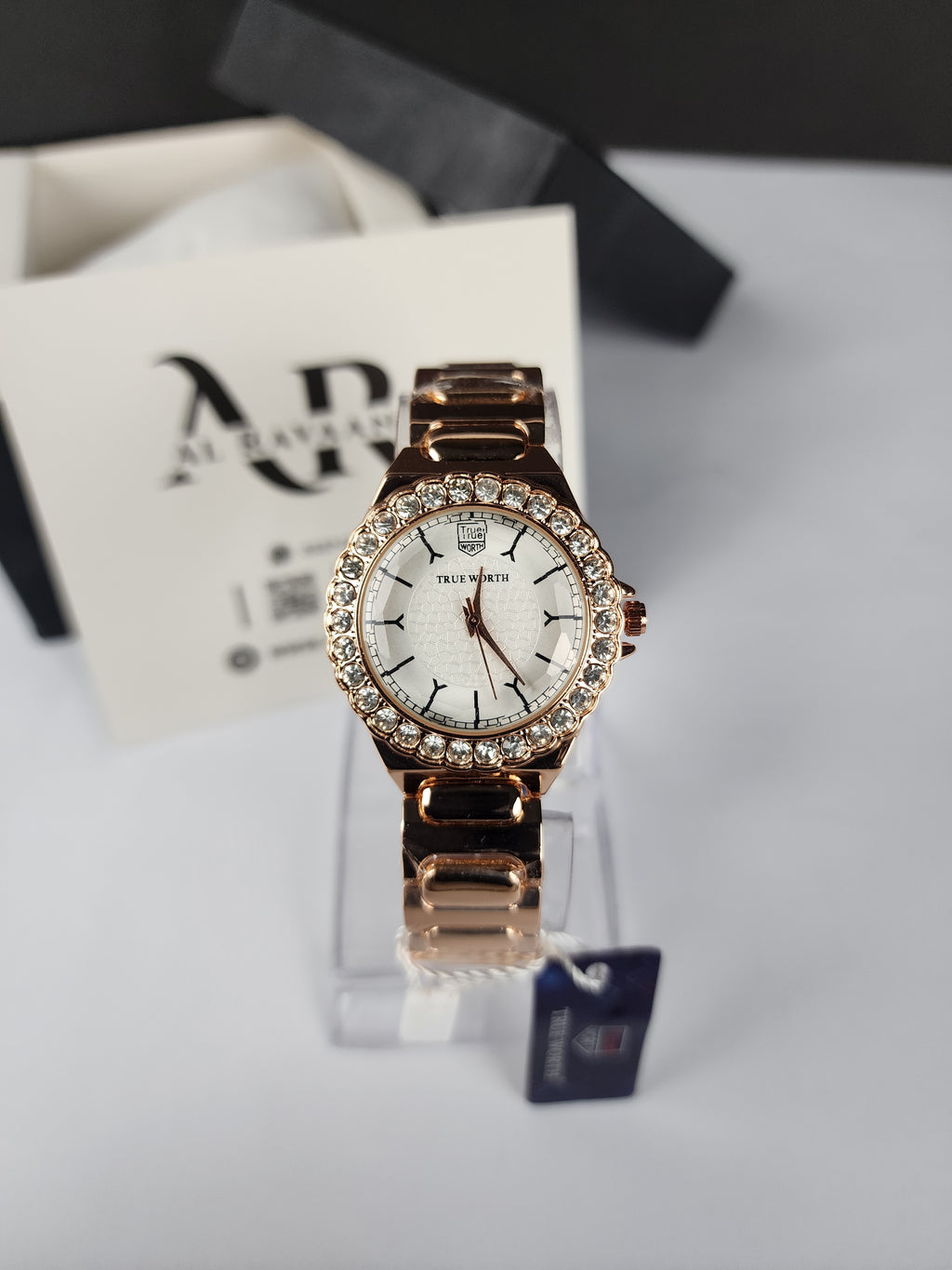 Rose gold watch with diamond accents on a white background